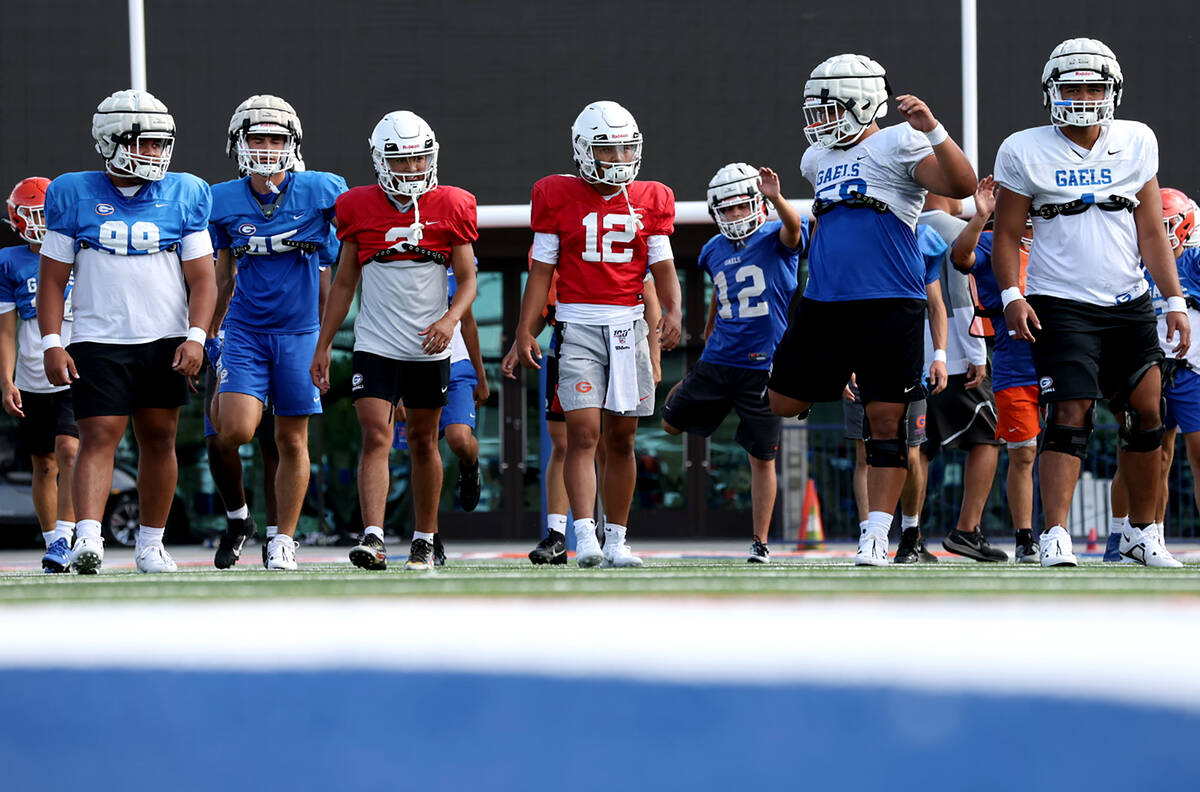 Bishop Gorman players warm up during football practice at Bishop Gorman High School on Wednesda ...