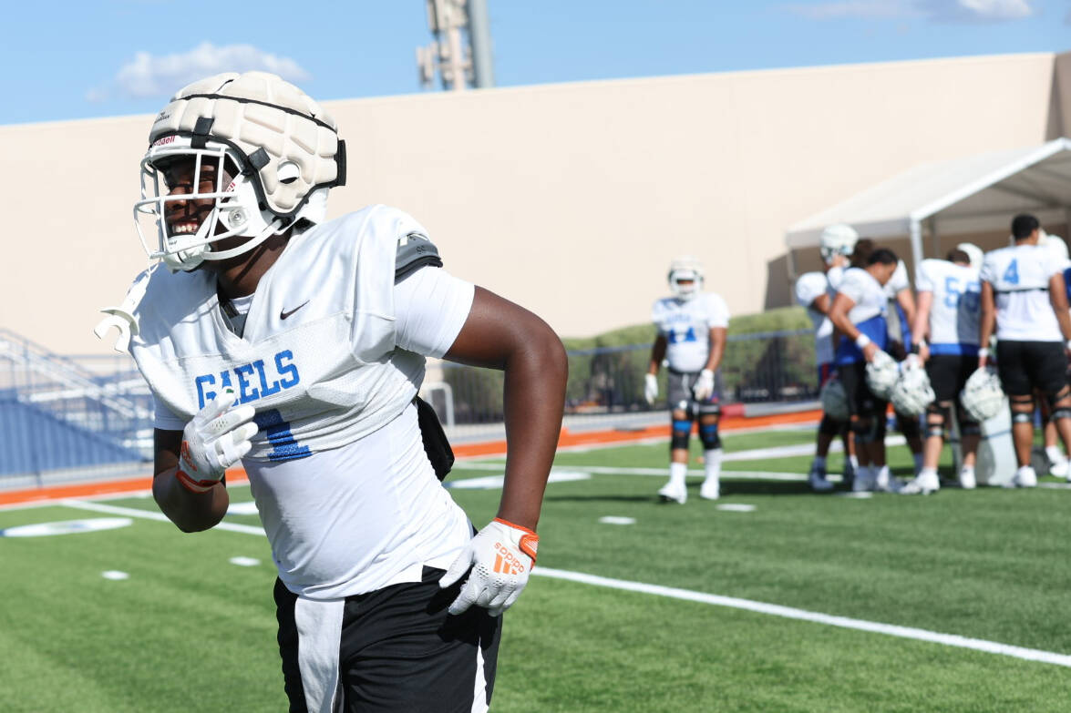 Bishop Gorman's Elija Lofton heads for a water break during football practice at Bishop Gorman ...