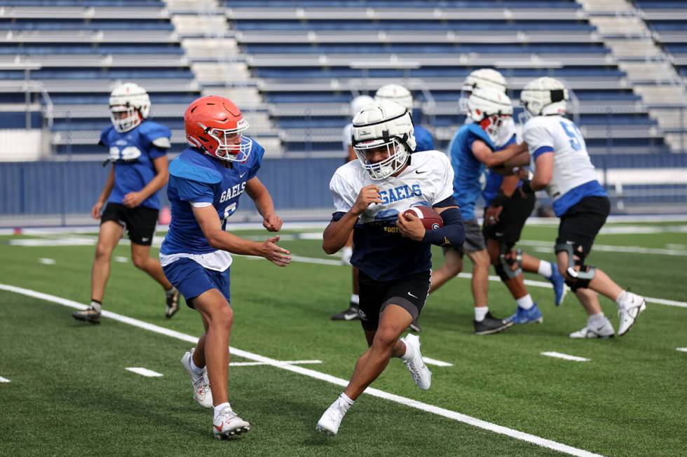 Bishop Gorman running back Micah Kaapana runs the ball during football practice at Bishop Gorma ...