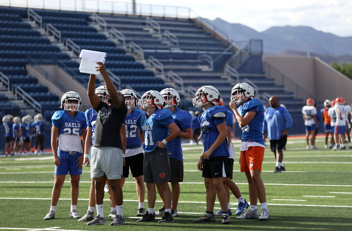 Bishop Gorman players read strategy during football practice at Bishop Gorman High School on We ...