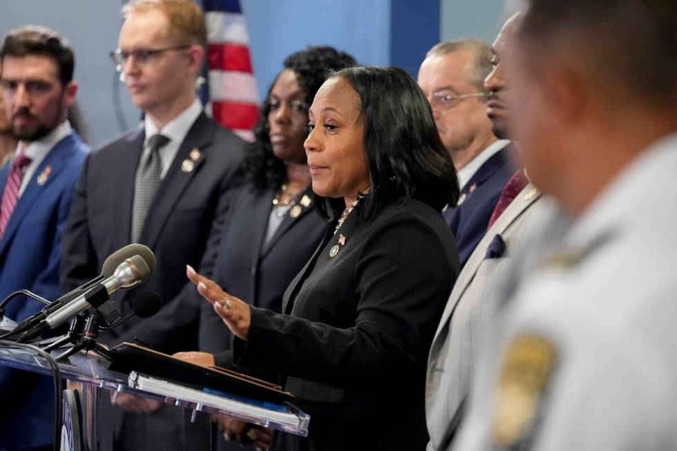 Fulton County District Attorney Fani Willis, center, speaks in the Fulton County Government Cen ...