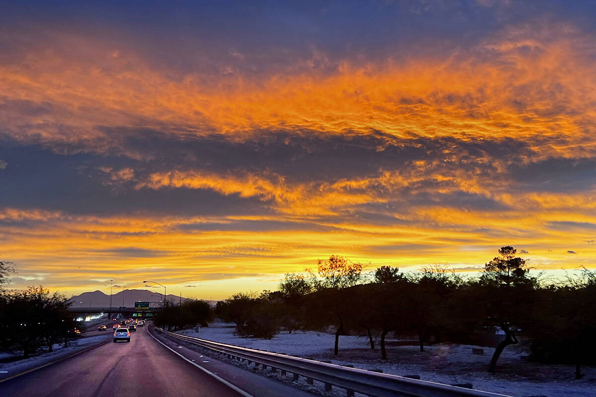The sky explodes in color as the sun rises in the east adjacent to the Summerlin Parkway on Wed ...