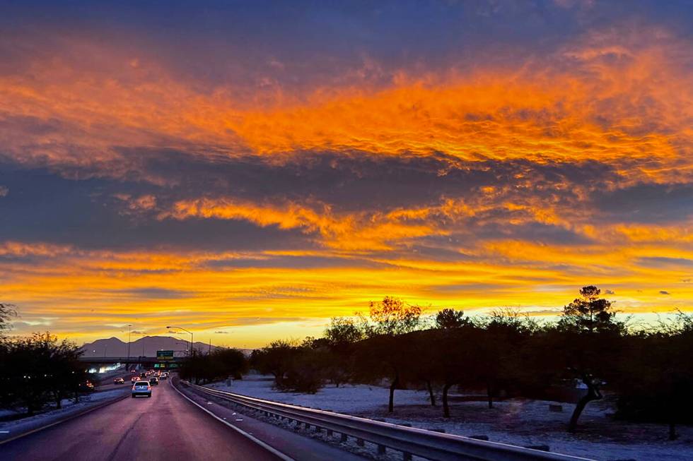 The sky explodes in color as the sun rises in the east adjacent to the Summerlin Parkway on Wed ...