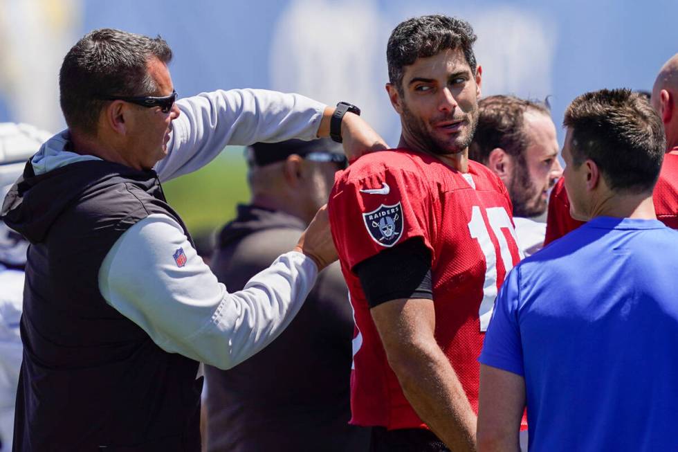 A member of the Las Vegas Raiders staff adjusts the jersey of Las Vegas Raiders quarterback Jim ...