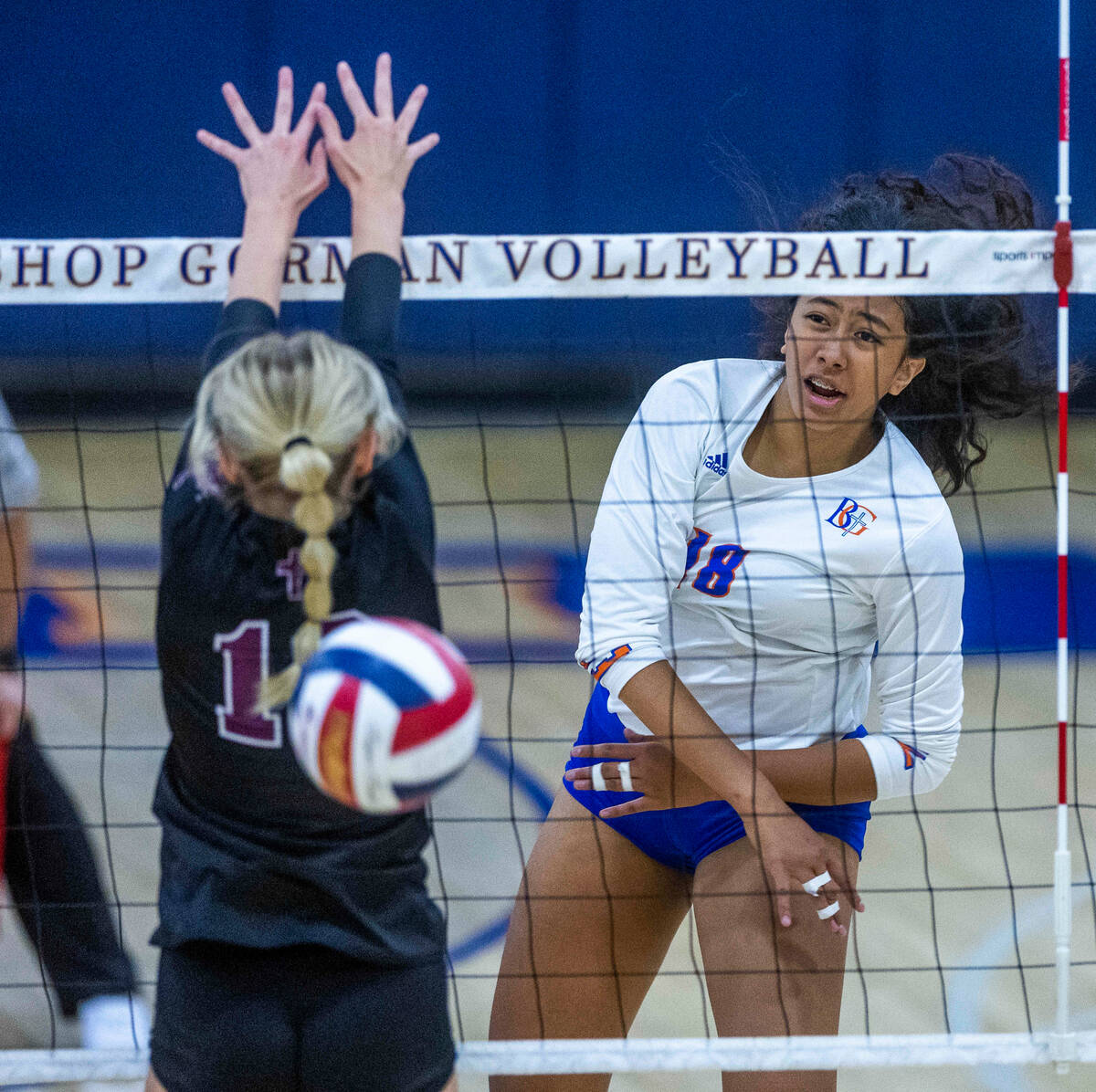 Bishop Gorman's Leilia Toailoa (18) sends a shot past Faith Lutheran's Ella Swinn (10) during t ...