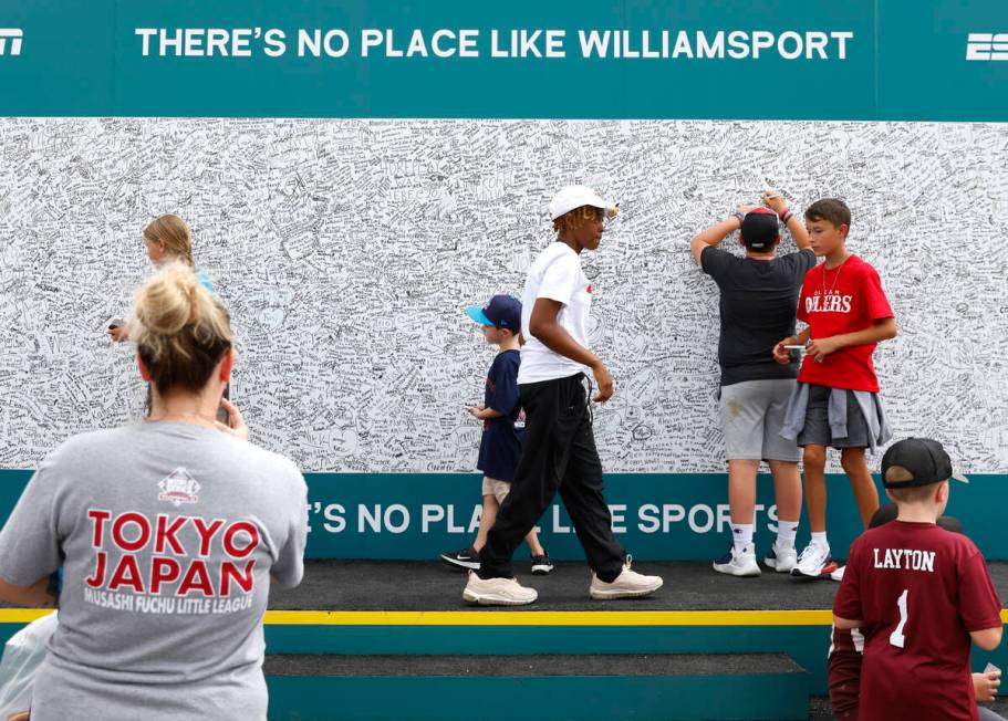 Fans write messages on a wall outside of Howard J. Lamade Stadium where the Little League World ...