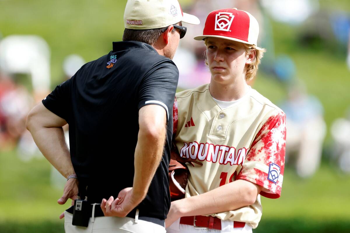 The Henderson All-Stars pitcher Nolan Gifford discusses with team manager Ryan Gifford on the m ...