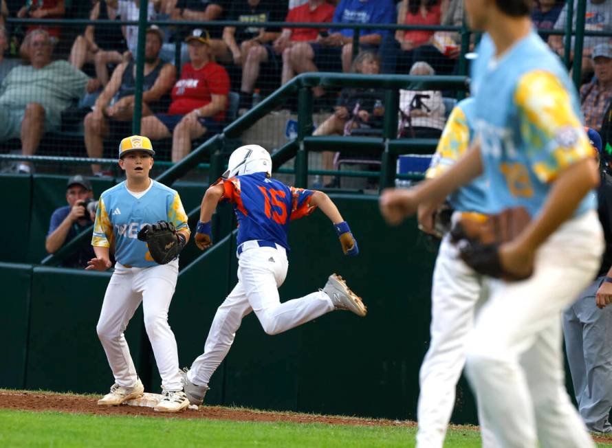 New Albany All-Stars Lincoln Luffler beats a throw and lands safe at first as El Segundo Califo ...