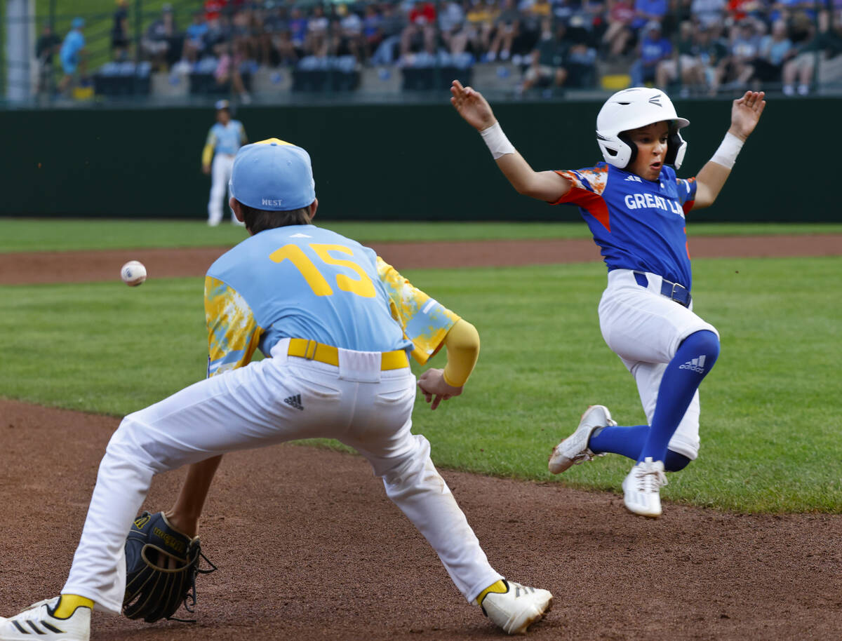 New Albany All-Stars shortstop Owen Nardell beats a throw and slides safe at third as El Segund ...