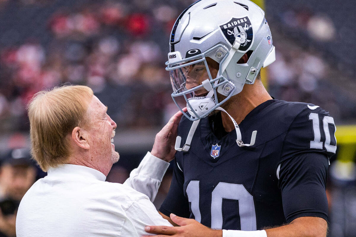 Raiders owner Mark Davis chats with quarterback Jimmy Garoppolo (10) during warm-ups before the ...