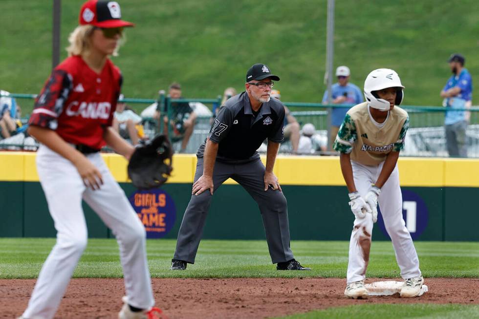 Second base umpire Ben Sprague of Las Vegas, center, watches play during the Little League Worl ...