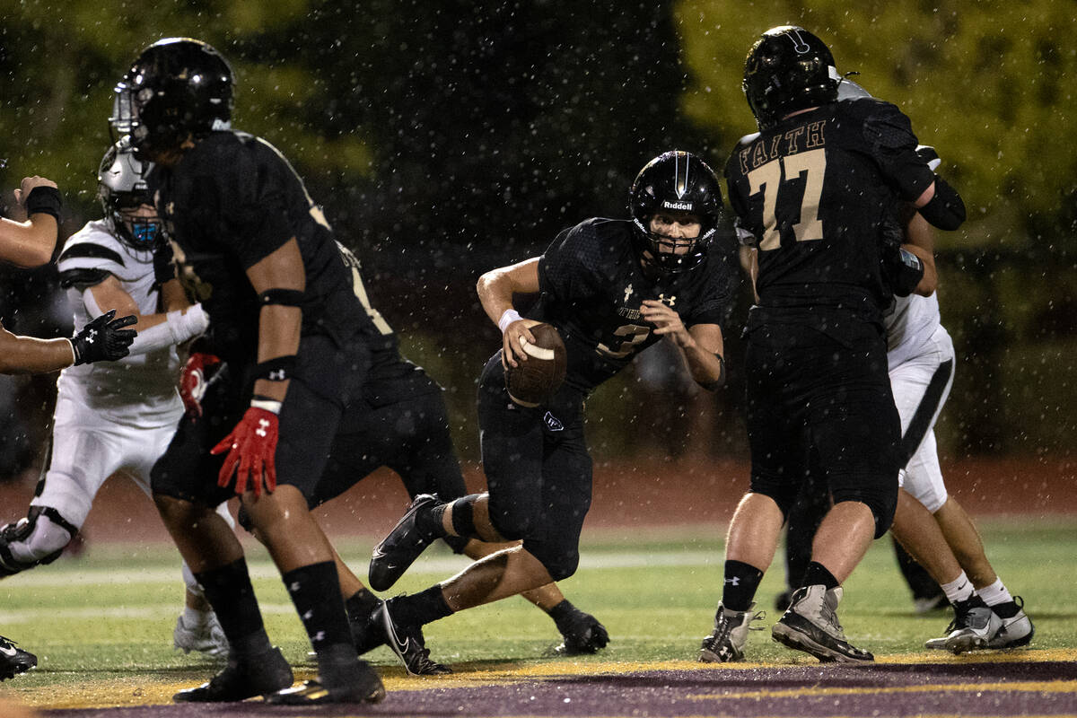 Faith Lutheran quarterback Garyt Odom (3) finds an opening to run the ball during the second ha ...