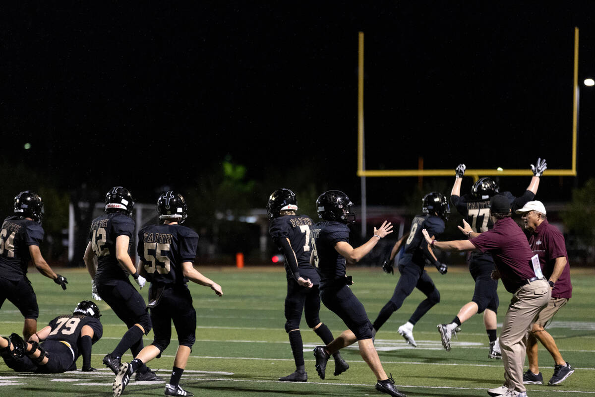 Faith Lutheran rushes to the bench to celebrate after winning a high school football game again ...