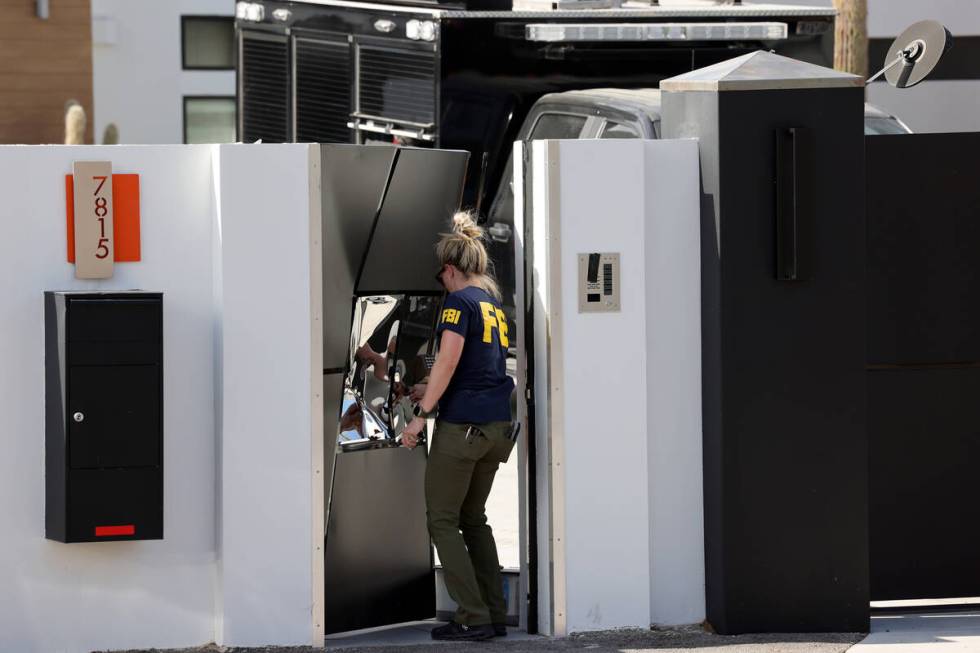 FBI personnel investigate at a home on the corner of West La Madre Way and Conough Lane in Las ...