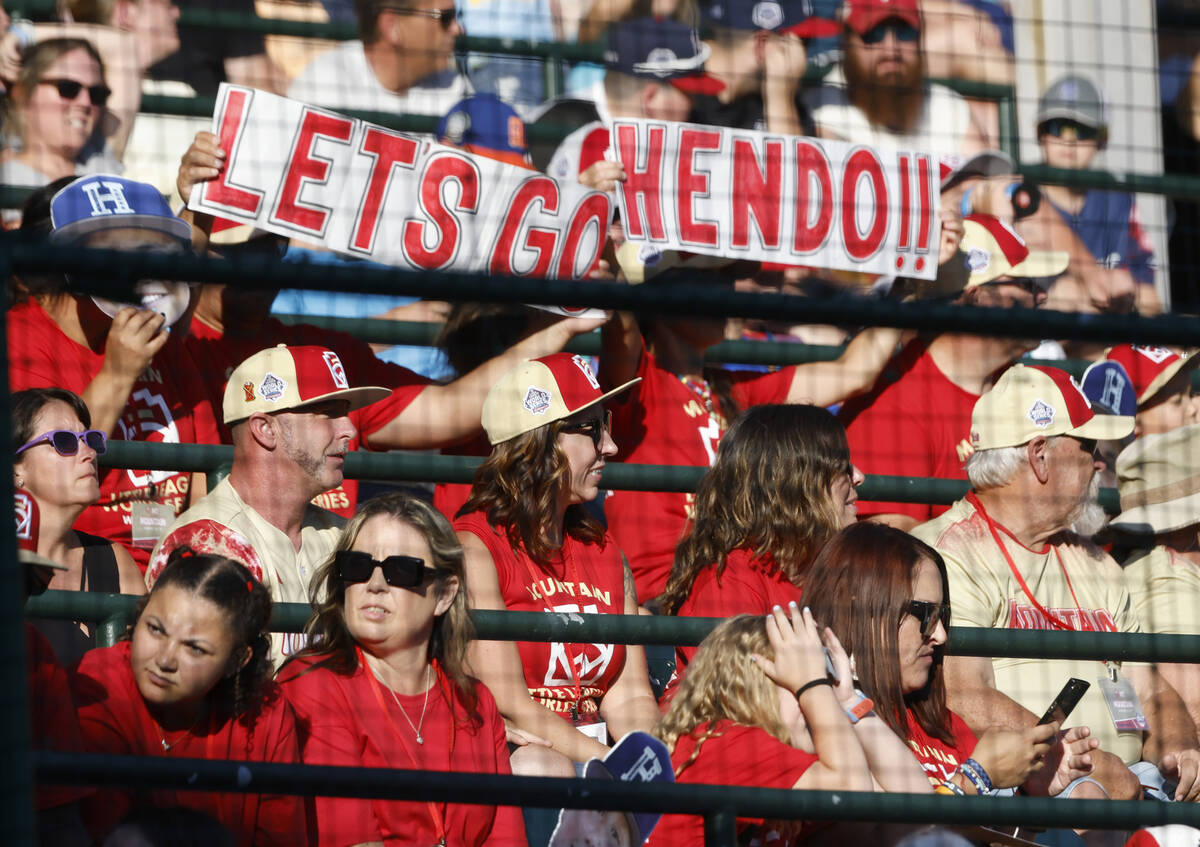 The Henderson All-Stars fans and parents who traveled from Henderson cheer for their team durin ...