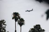 An airplane flies into Harry Reid International Airport on Saturday, August 19, 2023, in Las Ve ...