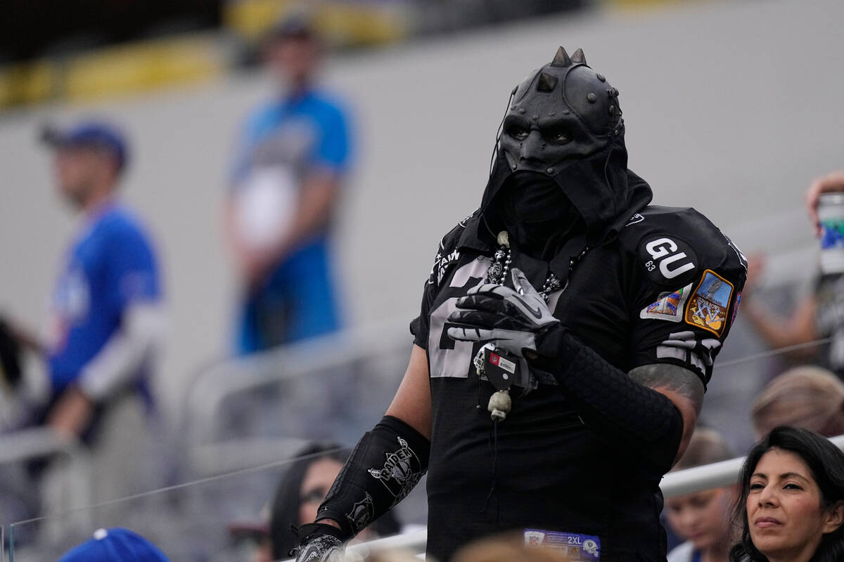 A Las Vegas Raiders fan looks on from the stands before a preseason NFL football game between t ...