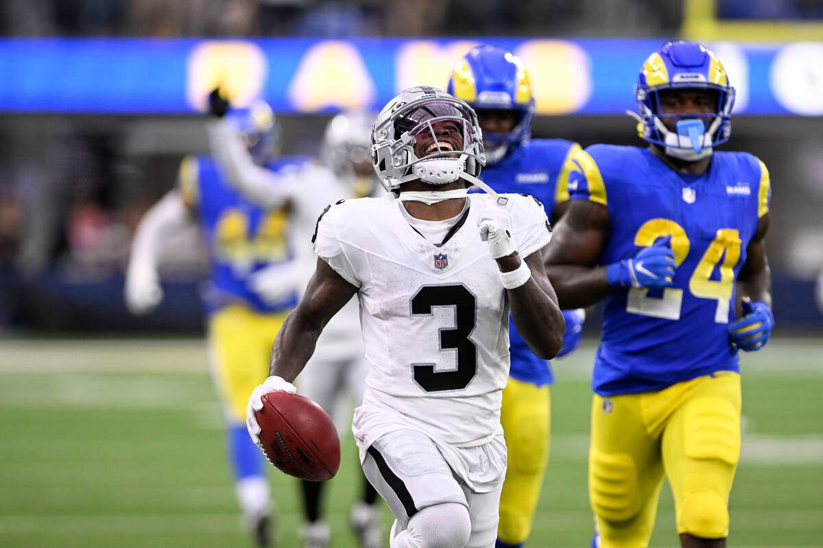Las Vegas Raiders' DeAndre Carter smiles as he runs with the football after stepping out of bou ...