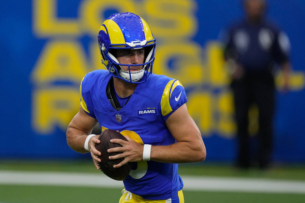 Los Angeles Rams quarterback Stetson Bennett rolls out during the first half of a preseason NFL ...