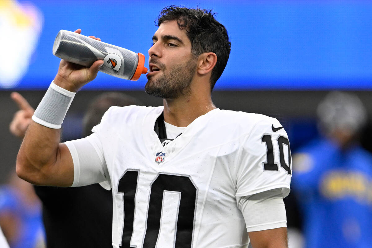 Las Vegas Raiders quarterback Jimmy Garoppolo takes a drink before a preseason NFL football gam ...