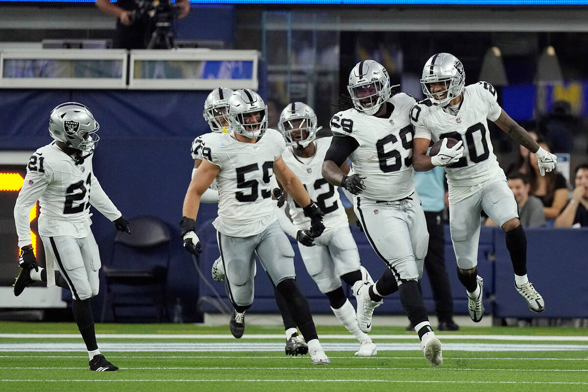 Las Vegas Raiders safety Isaiah Pola-Mao (20) celebrates with teammates after returning an inte ...