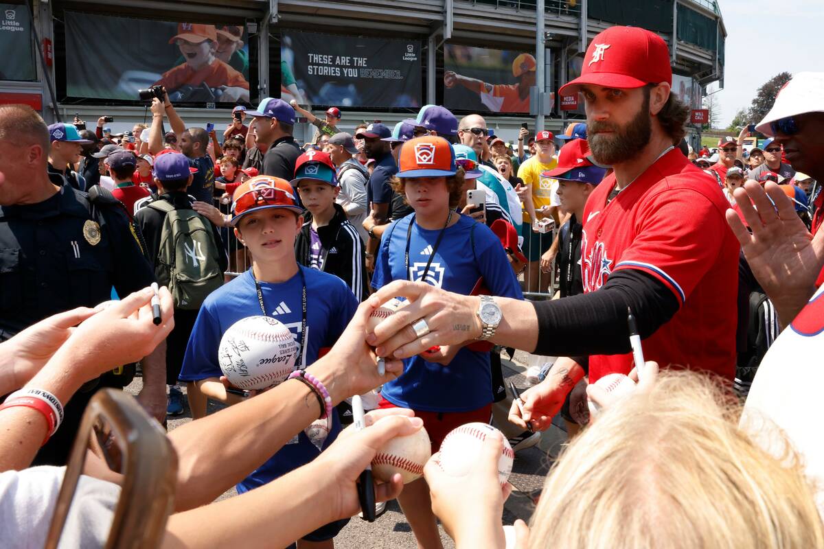 Las Vegas natives Bryce Harper of the Phillies signs autographs for fans outside of Howard J. L ...