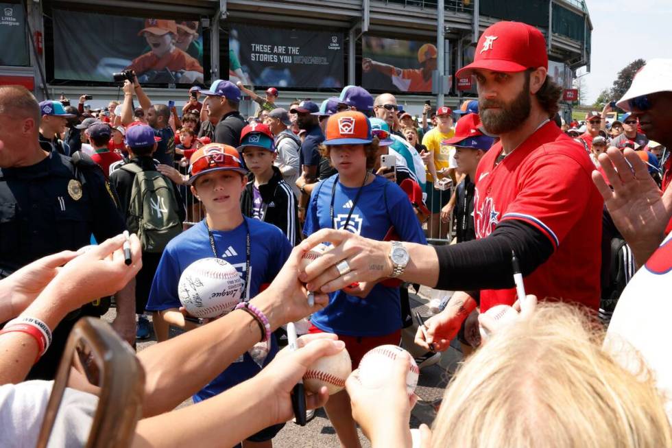 Las Vegas natives Bryce Harper of the Phillies signs autographs for fans outside of Howard J. L ...