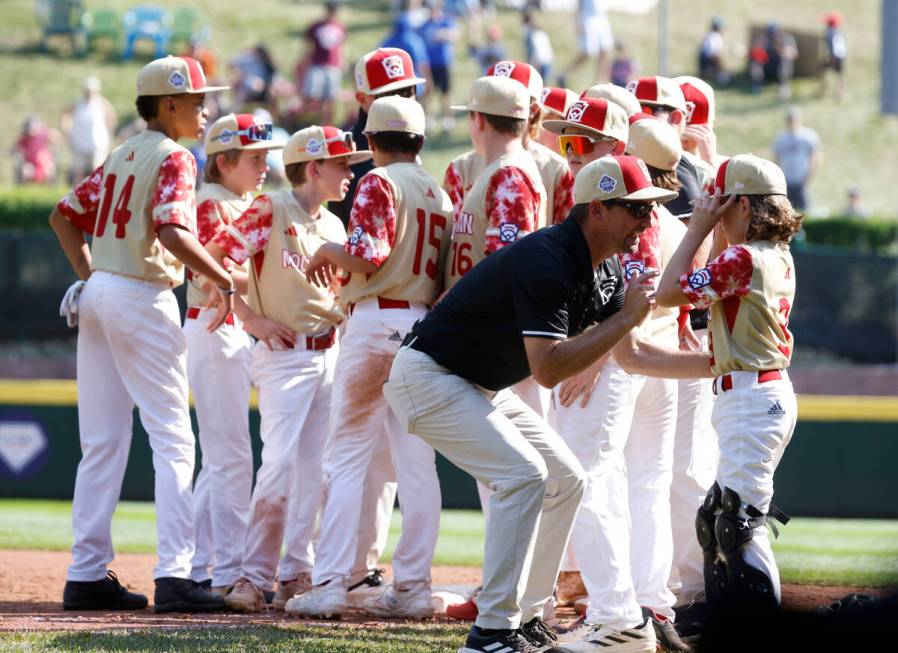 The Henderson All-Stars gathered to celebrate their win against Fargo, North Dakota, during the ...