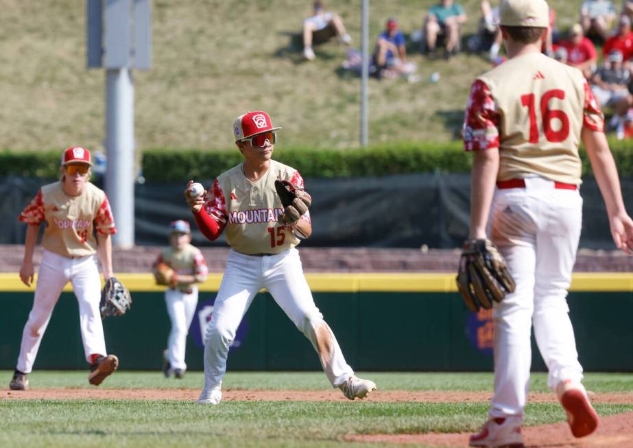 The Henderson All-Stars third baseman David Edwards prepares to throw for the out to first as p ...