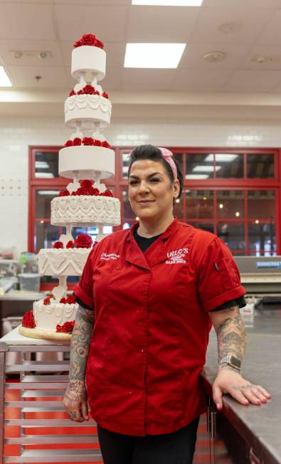 Carlo’s Bake Shop Las Vegas General Manager Christina Nasso is shown with a replica of Elvis ...