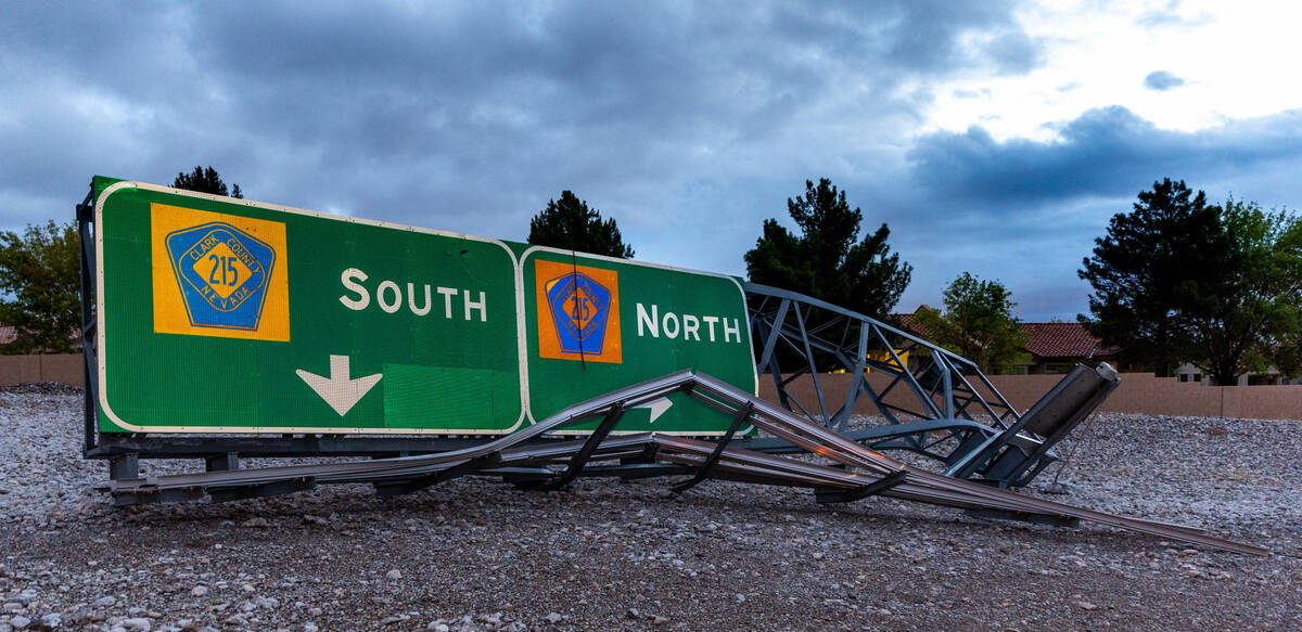 An Interstate 215 road sign is damaged on the side of the road as the remnants of tropical stor ...