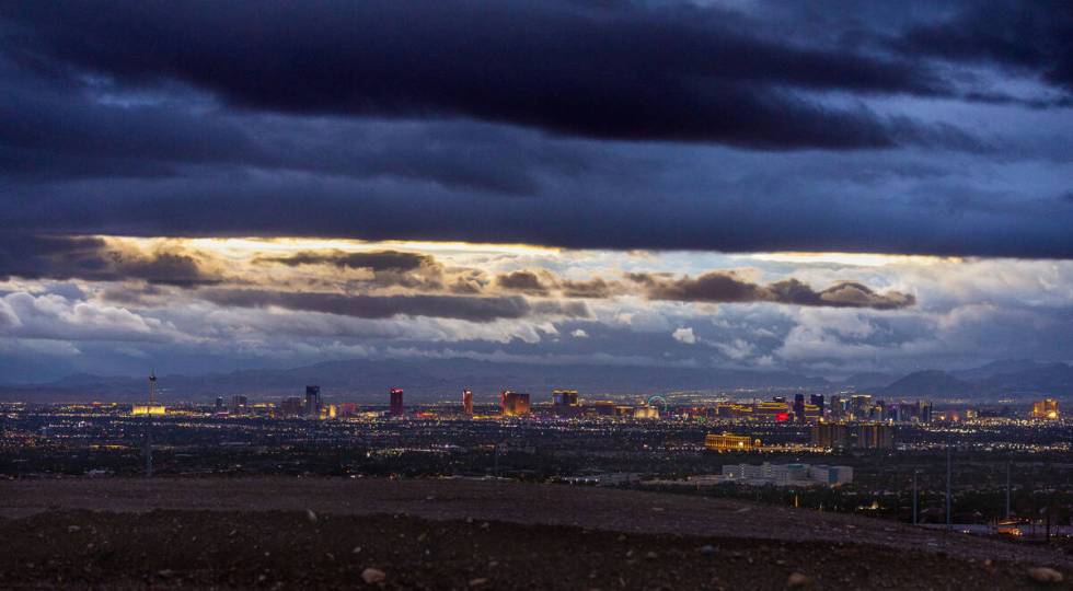 Dark clouds break a bit at sunrise as the remnants of tropical storm Hilary move through the re ...