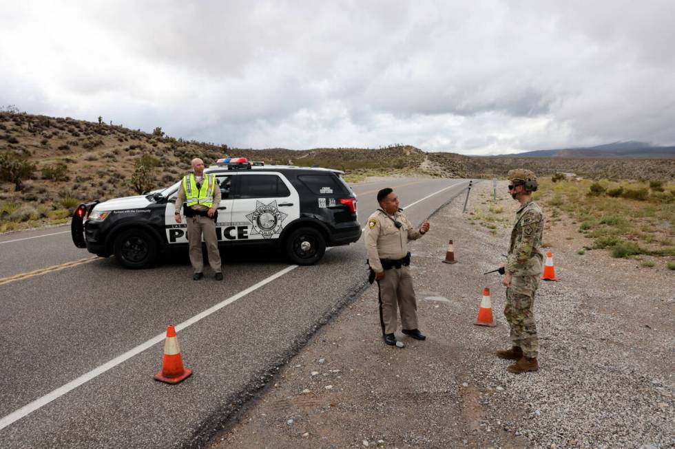 Nevada National Guard Military Police Sgt. Holsten, from right and Las Vegas police officers I. ...