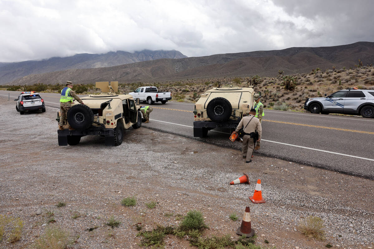 Nevada State Police, Las Vegas police and Nevada National Guard military police close the road ...