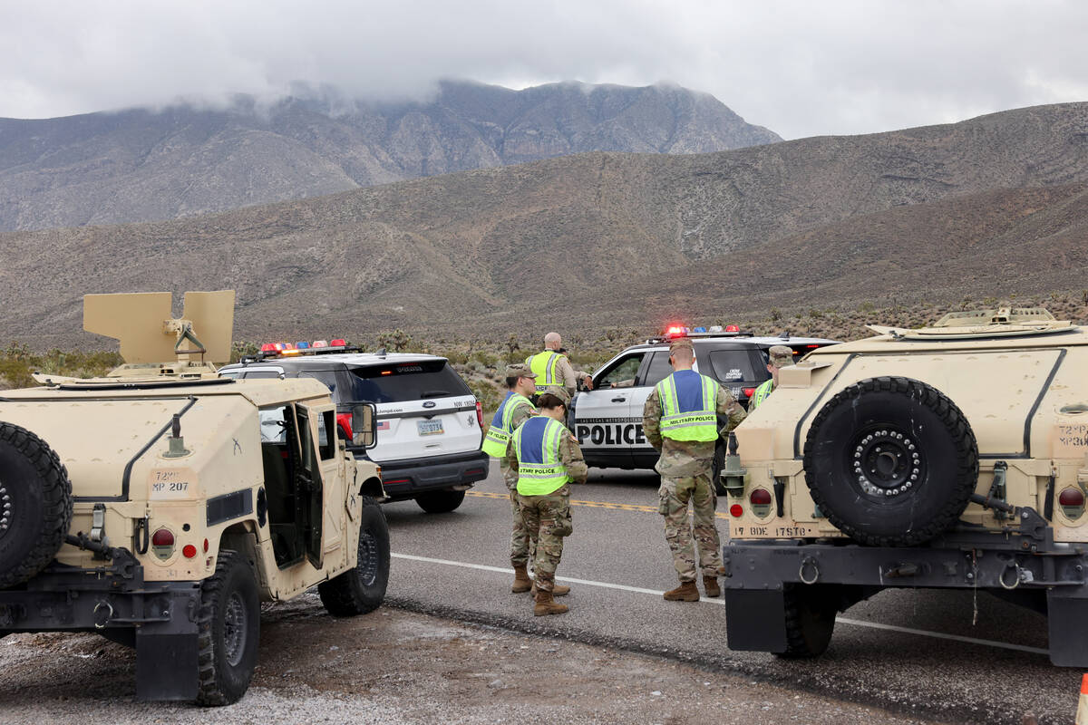 Nevada State Police, Las Vegas police and Nevada National Guard military police close the road ...