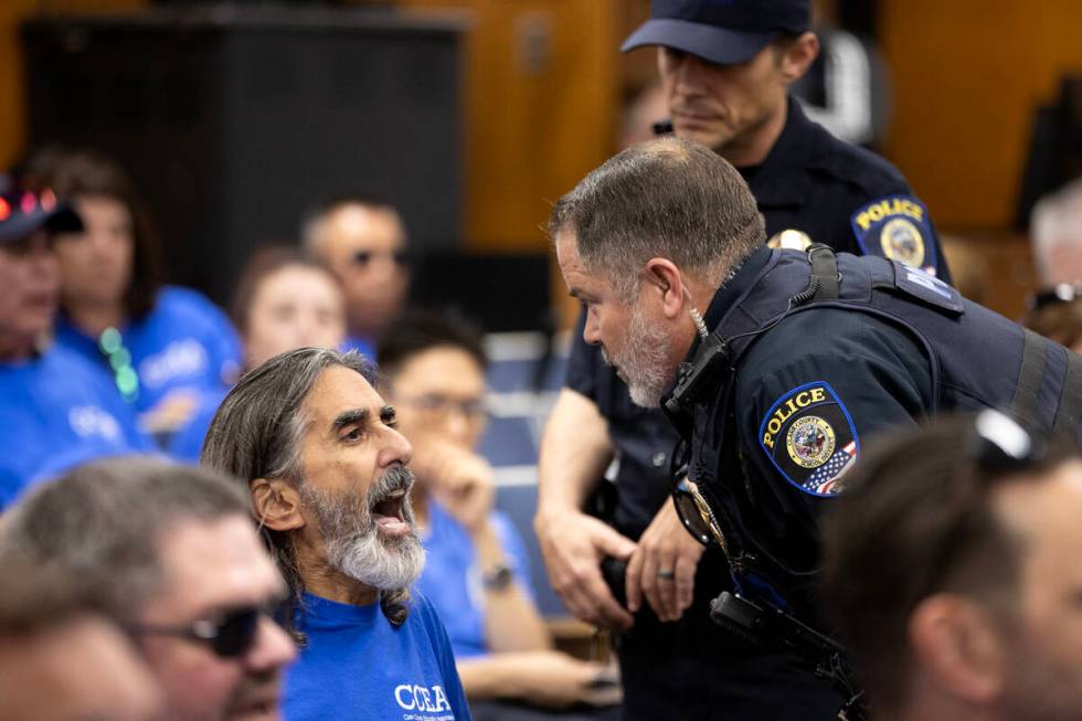 Aramis Bacallao, a teacher at Ernest A. Becker Middle School, shouts while a police officer att ...