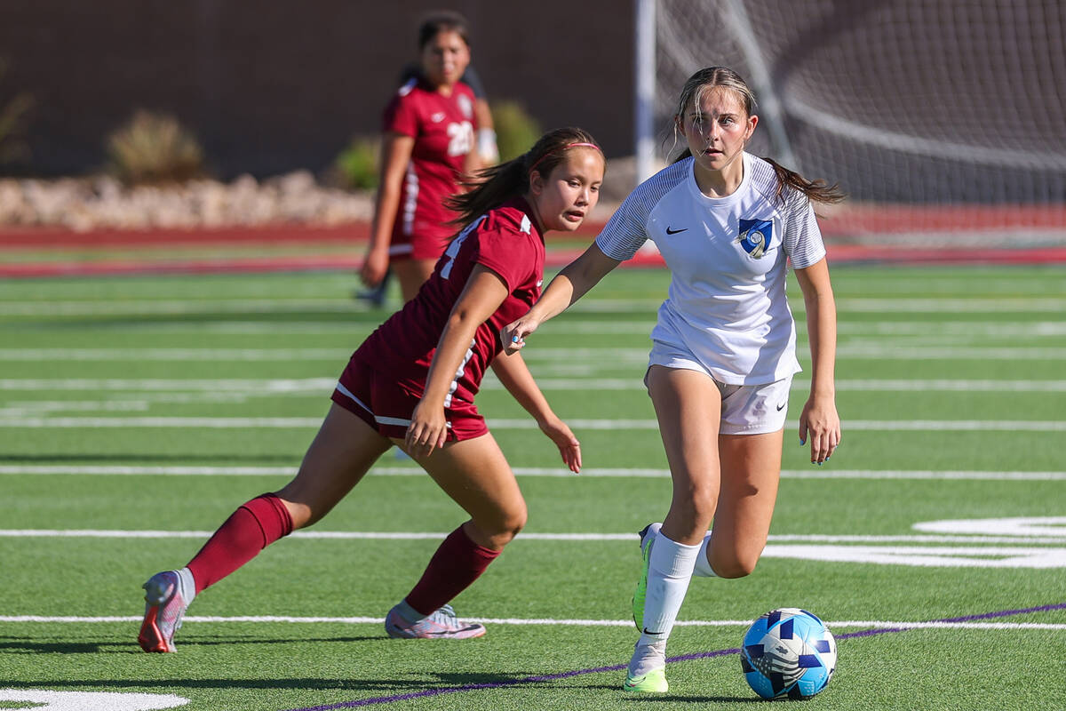 Foothill’s Ryan Koontz (2) and Desert Oasis’ Ava Smith (4) fight for the ball during a socc ...