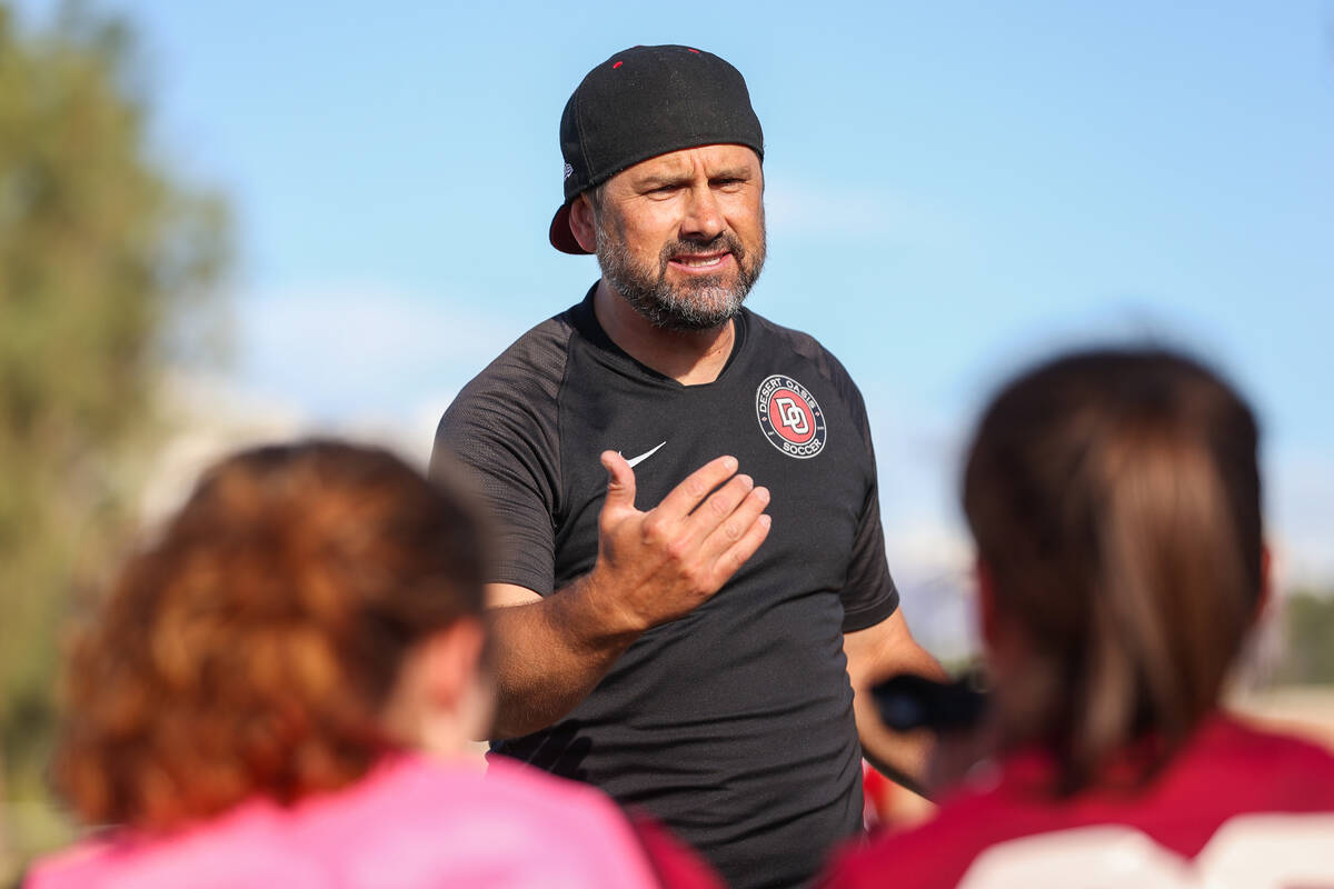 Jared Ogden, Desert Oasis girls soccer head coach, talks to his players during halftime at a so ...