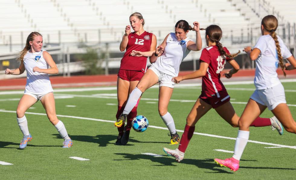 Foothill’s Riley Aldrich (13) and Desert Oasis’ Taylor Wehrer (12) fight for the ball durin ...