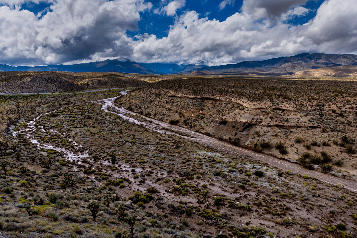 A fast-moving wash of water comes from Mount Charleston on Monday, Aug. 21, 2023, in Las Vegas. ...