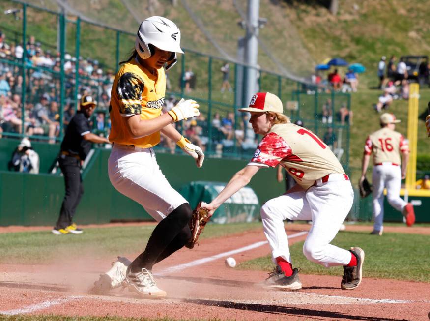 Nolensville, Tennessee, designated hitter Stella Weaver beats a throw and scores as Henderson A ...