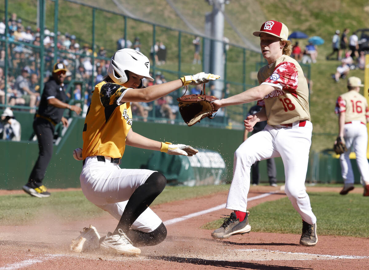 Nolensville, Tennessee, designated hitter Stella Weaver beats a throw and scores as Henderson A ...