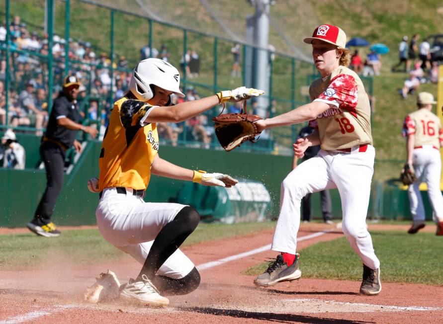 Nolensville, Tennessee, designated hitter Stella Weaver beats a throw and scores as Henderson A ...