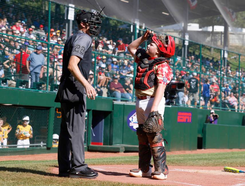 The Henderson All-Stars catcher Arlie Daniel IV reacts to the home plate umpire Dave Miller's c ...