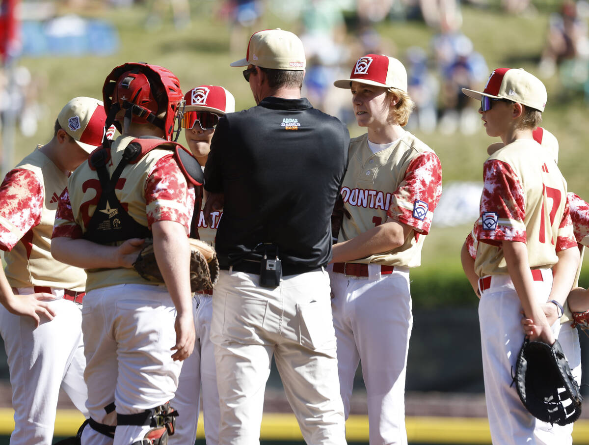 The Henderson All-Stars manager Ryan Gifford talks to his players, including starting pitcher N ...