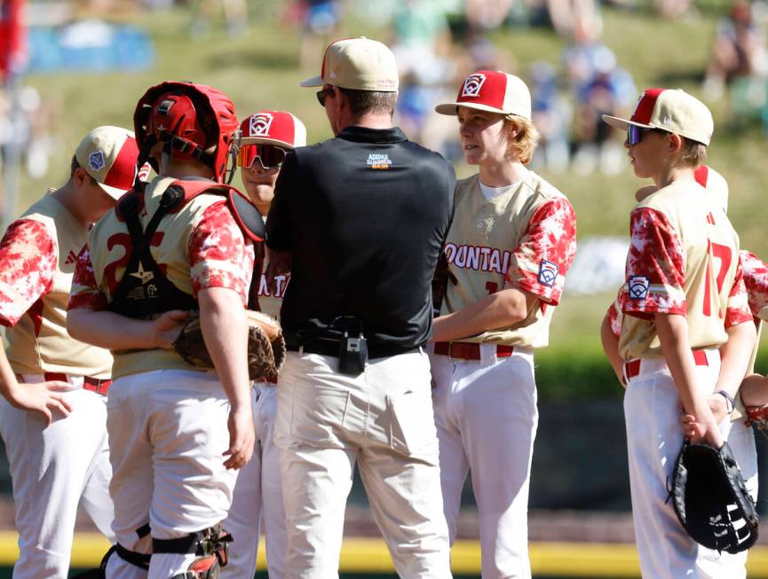 The Henderson All-Stars manager Ryan Gifford talks to his players, including starting pitcher N ...