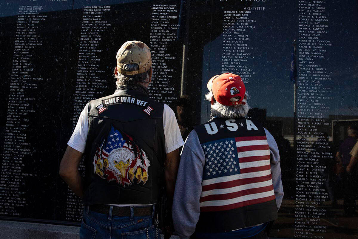 Army veteran Paul Martinez, 64, left, and retired Army National Guard Teofilo, 66, watch their ...