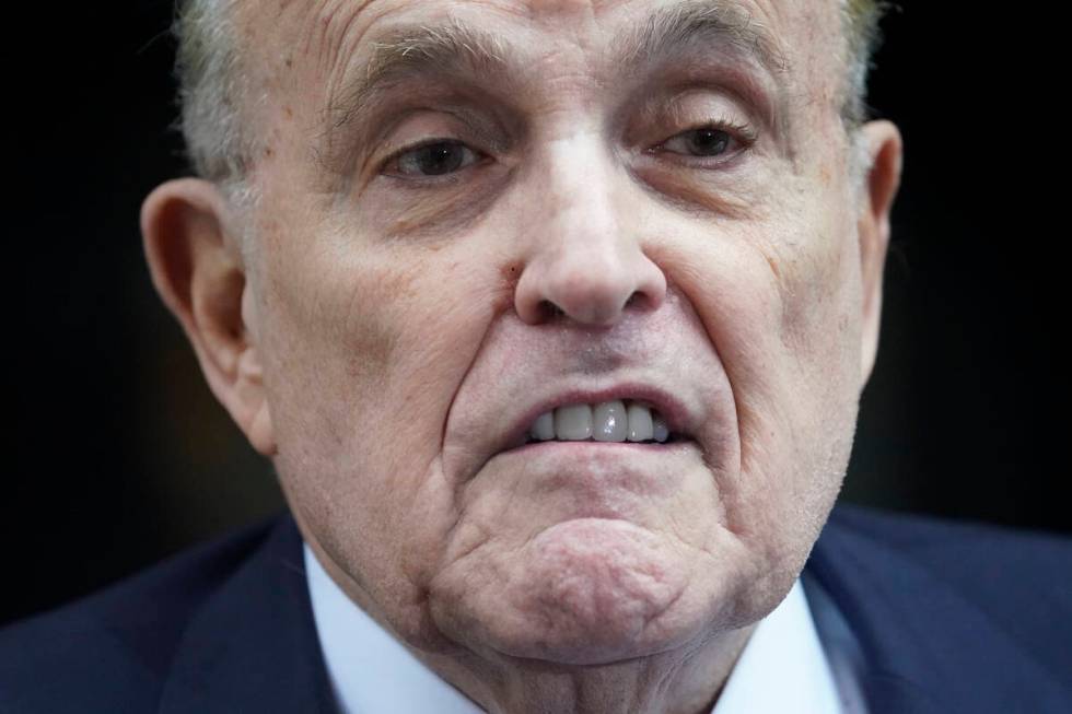 Former New York Mayor Rudy Giuliani speaks to reporters as he leaves his apartment building in ...