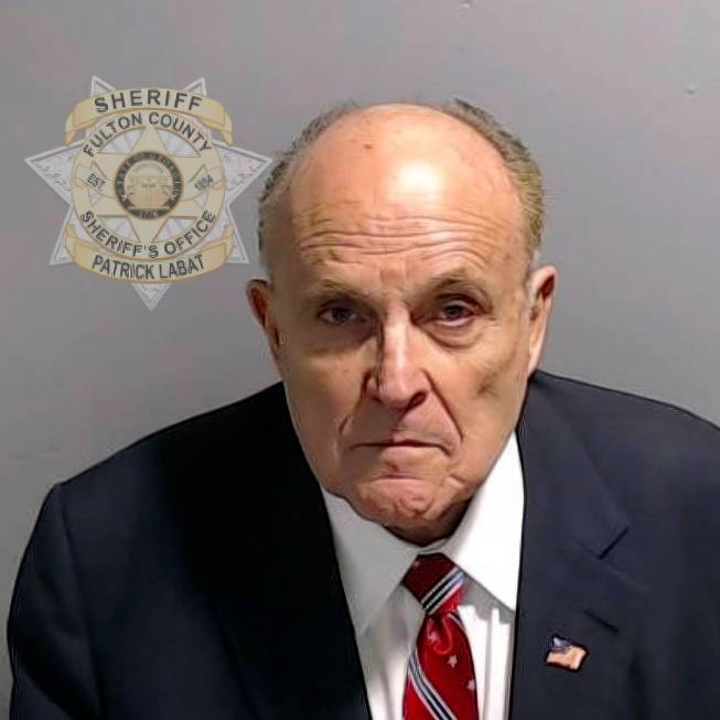 This booking photo provided by the Fulton County Sheriff's Office shows Rudy Giuliani on Wednes ...