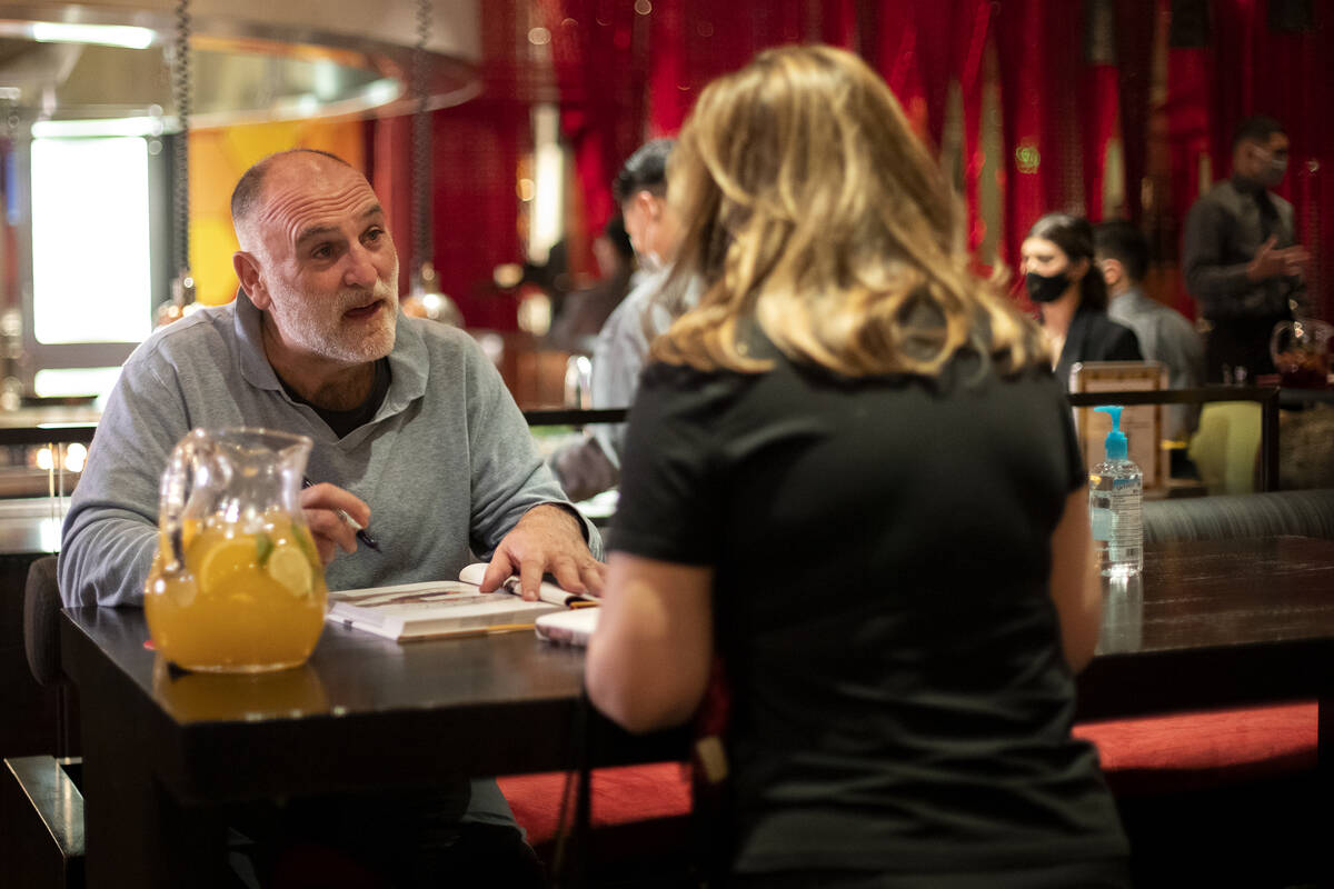 Celebrity chef Jose Andres signs a copy of one his books for Sandy Tagle at his restaurant Jale ...